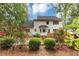 Exterior of home with well-manicured lawn, mature trees, lush landscaping, and colorful flowers at 115 Blue Ridge Trl, Powder Springs, GA 30127