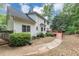 Exterior of home featuring deck, well-manicured lawn, mature trees, and lush landscaping at 115 Blue Ridge Trl, Powder Springs, GA 30127