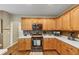Updated kitchen features stainless steel appliances, light wood cabinetry, and tile backsplash at 115 Blue Ridge Trl, Powder Springs, GA 30127