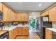 Bright kitchen features light wood cabinets, stainless steel appliances, and lots of counter space at 115 Blue Ridge Trl, Powder Springs, GA 30127
