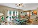 Open concept living room with hardwood floors, lots of plants, and a view of the outdoor deck at 115 Blue Ridge Trl, Powder Springs, GA 30127