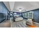 Large main bedroom featuring tray ceilings, decorative mirrors, hardwood floors, and great natural light at 115 Blue Ridge Trl, Powder Springs, GA 30127