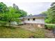 The backyard of this home features a lush lawn, mature trees, and a back porch at 2923 Bicentennial Dr, Stone Mountain, GA 30087