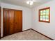 This cozy bedroom has a ceiling fan, plush carpet, and a window to provide ample natural light at 2923 Bicentennial Dr, Stone Mountain, GA 30087