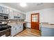 Updated kitchen features stainless steel appliances, granite counters, and a decorative tile backsplash at 2923 Bicentennial Dr, Stone Mountain, GA 30087
