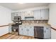 Close up of a modern kitchen with gray cabinets, granite countertops and stainless steel appliances at 2923 Bicentennial Dr, Stone Mountain, GA 30087
