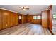 Spacious living room with wood paneling, new floors, and a ceiling fan at 2923 Bicentennial Dr, Stone Mountain, GA 30087