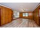 Spacious living room with wood paneling, new floors, and view to backyard at 2923 Bicentennial Dr, Stone Mountain, GA 30087