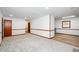 Open layout with carpet, light walls, wood trim, with a partial view into the adjacent kitchen at 2923 Bicentennial Dr, Stone Mountain, GA 30087