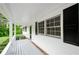 Cozy covered porch with freshly painted railings, black shutters, and a brick foundation at 2923 Bicentennial Dr, Stone Mountain, GA 30087