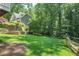 Expansive backyard featuring a lush lawn and mature trees, creating a private oasis at 4586 Smoke Rise Ln, Marietta, GA 30062
