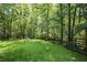 Beautiful backyard lawn with mature trees and a peaceful seating area at 4586 Smoke Rise Ln, Marietta, GA 30062