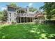 Beautiful backyard with a spacious deck, covered patio, lush lawn, and mature trees for outdoor enjoyment at 4586 Smoke Rise Ln, Marietta, GA 30062