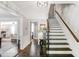 Elegant entryway with a staircase, dark wood flooring, white trim, and views into the living spaces at 4586 Smoke Rise Ln, Marietta, GA 30062
