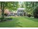 Charming gray brick home with a lush green lawn and mature trees in a desirable neighborhood at 4586 Smoke Rise Ln, Marietta, GA 30062