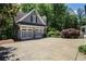 A two-car garage with matching trim sits surrounded by lush greenery and plenty of parking space at 4586 Smoke Rise Ln, Marietta, GA 30062