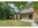 A spacious backyard featuring a patio, lush green lawn, and mature trees, providing a serene outdoor living space at 1406 Dolcetto Nw Trce # 13, Kennesaw, GA 30152