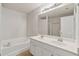 Bright bathroom features double sinks, soaking tub, and a large mirror at 1406 Dolcetto Nw Trce # 13, Kennesaw, GA 30152