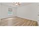 Bright bedroom featuring hardwood floors, a ceiling fan, and a window with natural light at 1406 Dolcetto Nw Trce # 13, Kennesaw, GA 30152