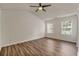 Bright bedroom with vaulted ceiling, ceiling fan, two windows, and modern wood flooring at 1406 Dolcetto Nw Trce # 13, Kennesaw, GA 30152