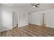 Spacious primary bedroom with vaulted ceiling, ceiling fan, and modern wood flooring and multiple doors at 1406 Dolcetto Nw Trce # 13, Kennesaw, GA 30152