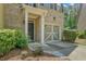 Inviting home exterior featuring a well-maintained lawn, front door, and attached one-car garage at 1406 Dolcetto Nw Trce # 13, Kennesaw, GA 30152