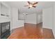 Spacious and bright living room with a fireplace, wood floors, and open access to the entryway at 1406 Dolcetto Nw Trce # 13, Kennesaw, GA 30152