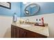 Bathroom featuring a granite vanity top and a decorative mirror at 1767 Hunters Sw Trce, Lilburn, GA 30047