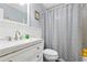 Charming bathroom featuring a bright vanity, decorative mirror, and stylish geometric patterned shower curtain at 1767 Hunters Sw Trce, Lilburn, GA 30047