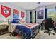 Vibrant bedroom showcasing a well-decorated bed, gaming setup, and natural light from the window at 1767 Hunters Sw Trce, Lilburn, GA 30047