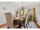 Elegant dining room featuring hardwood floors, chandelier lighting, and a decorative rug at 1767 Hunters Sw Trce, Lilburn, GA 30047