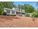 Charming two-story home with a welcoming front porch, dormer windows, and beautifully landscaped yard at 1767 Hunters Sw Trce, Lilburn, GA 30047