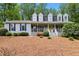 Charming home featuring a welcoming front porch, blue shutters, dormer windows, and a well-maintained front yard at 1767 Hunters Sw Trce, Lilburn, GA 30047