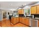Open kitchen with stainless steel appliances, granite counters, wood cabinets, and an eat-in breakfast area at 1767 Hunters Sw Trce, Lilburn, GA 30047