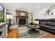 Cozy living room with built-in shelves, a brick fireplace, and comfortable seating at 1767 Hunters Sw Trce, Lilburn, GA 30047