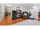 Relaxing room with hardwood floors, cozy chair, bookshelf, and natural light at 1767 Hunters Sw Trce, Lilburn, GA 30047