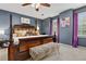 Main bedroom features a four poster bed, purple accents, and decorative pillows at 1767 Hunters Sw Trce, Lilburn, GA 30047