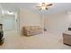 Finished basement with tile flooring, a tan sofa, and white walls at 2185 Arbor Chase, Cumming, GA 30041