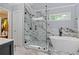 Luxurious bathroom features a marble shower, soaking tub, and elegant finishes at 2185 Arbor Chase, Cumming, GA 30041
