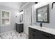 Bright bathroom with dual vanities, modern fixtures, and stylish marble floors at 2185 Arbor Chase, Cumming, GA 30041