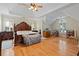 Spacious primary bedroom with tray ceiling, hardwood floors, and large windows at 2185 Arbor Chase, Cumming, GA 30041
