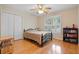 Bedroom with hardwood floors, a ceiling fan and double door closet at 2185 Arbor Chase, Cumming, GA 30041