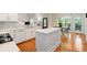 Pristine white kitchen with quartz countertops, an island, and direct access to the outdoor deck at 2185 Arbor Chase, Cumming, GA 30041