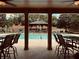 Community pool with lounging and tables offers a relaxing space for residents to gather at 2185 Arbor Chase, Cumming, GA 30041