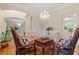 Cozy sitting area with decorative chandelier and four plush armchairs at 2185 Arbor Chase, Cumming, GA 30041