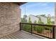Balcony with wooden floors and railing, offering a view of trees and nearby buildings at 3592 Parkhaven Pl, Brookhaven, GA 30319