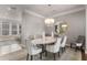 Traditional dining room is decorated with neutral paint, an elegant chandelier and decorative mirror at 3592 Parkhaven Pl, Brookhaven, GA 30319