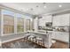 Bright kitchen features white cabinetry, quartz countertops, stainless appliances and a breakfast bar at 3592 Parkhaven Pl, Brookhaven, GA 30319