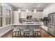 Bright eat-in kitchen features white cabinetry, quartz countertops, stainless appliances and a breakfast bar at 3592 Parkhaven Pl, Brookhaven, GA 30319