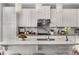 Bright kitchen features white cabinetry, quartz countertops, stainless appliances and a breakfast bar at 3592 Parkhaven Pl, Brookhaven, GA 30319